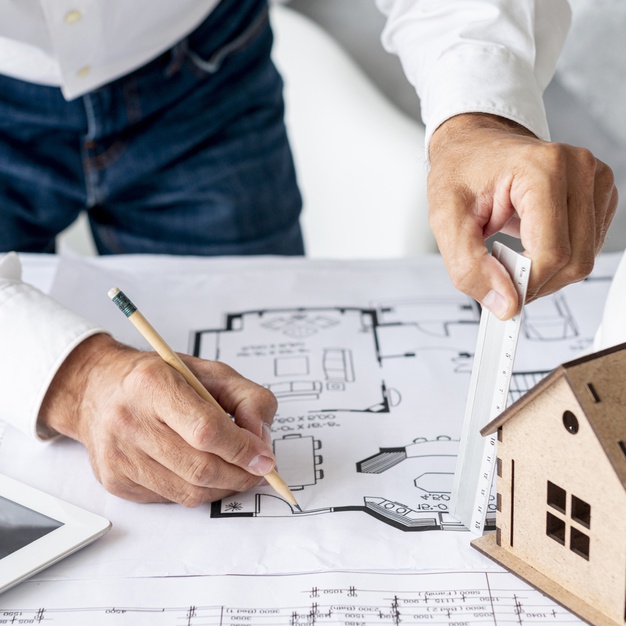 high-angle-architect-working-building-plans_23-2148243000